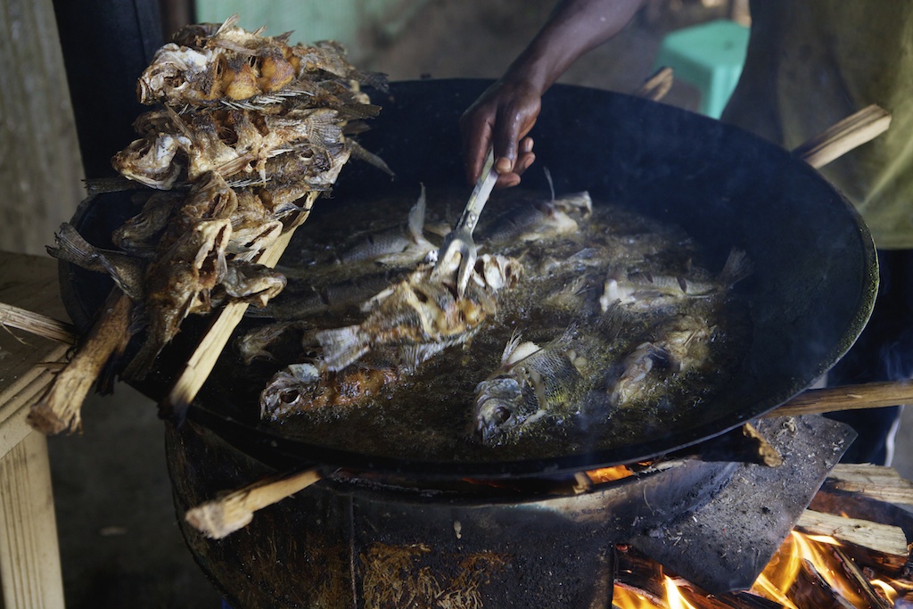 A wok frying fish