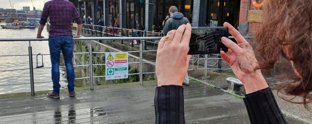 woman using a smartphone on a filmmaking course