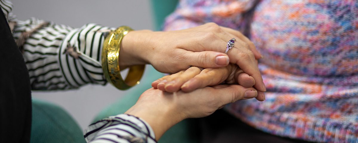 A close up of a lady holding someones hands