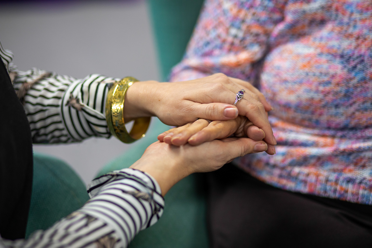 A close up of a lady holding someones hands